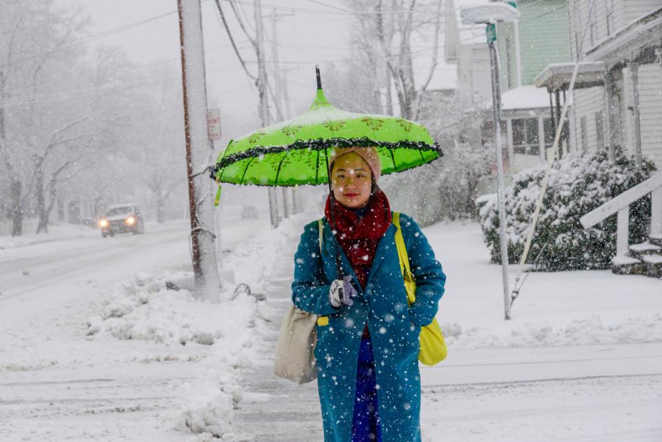 Yiren Zheng of Hanover, N.H., uses an umbrella to keep dry while walking down Atkinson Street in Bellows Falls, Vt., on Thursday, April 4, 2024. (Kristopher Radder/The Brattleboro Reformer via AP)