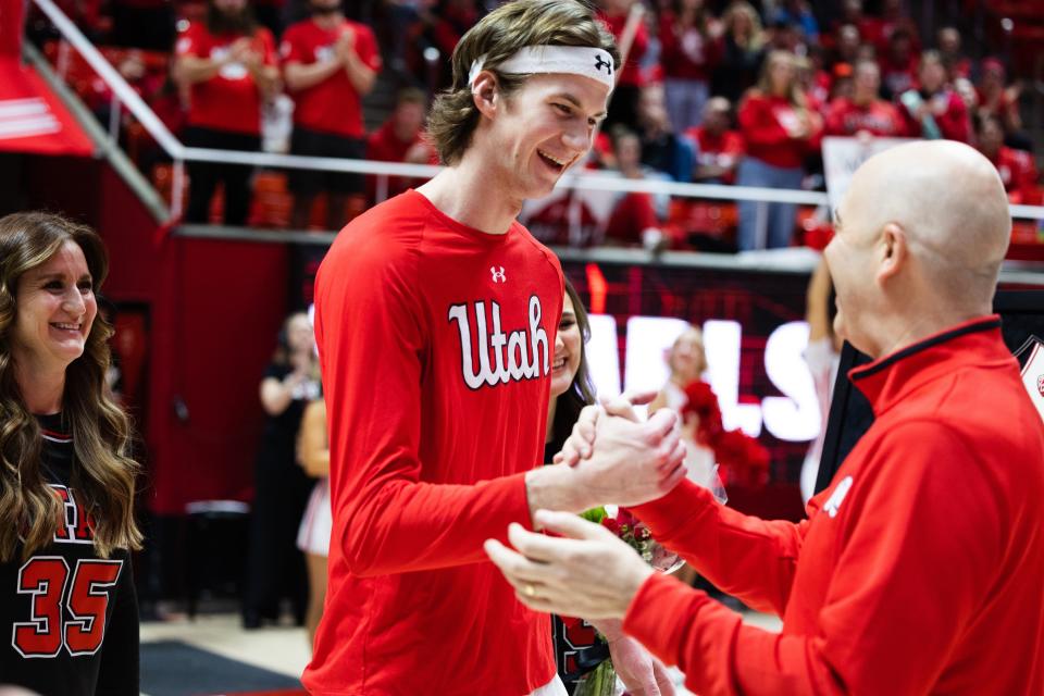 Utah Utes center Branden Carlson is honored on Senior Night by coach Craig Smith, right, during game at the Huntsman Center in Salt Lake City on Saturday, Feb. 25, 2023. Much to Smith’s delight, Carlson recently announced that he is returning to the Utes for one more year. | Ryan Sun, Deseret News