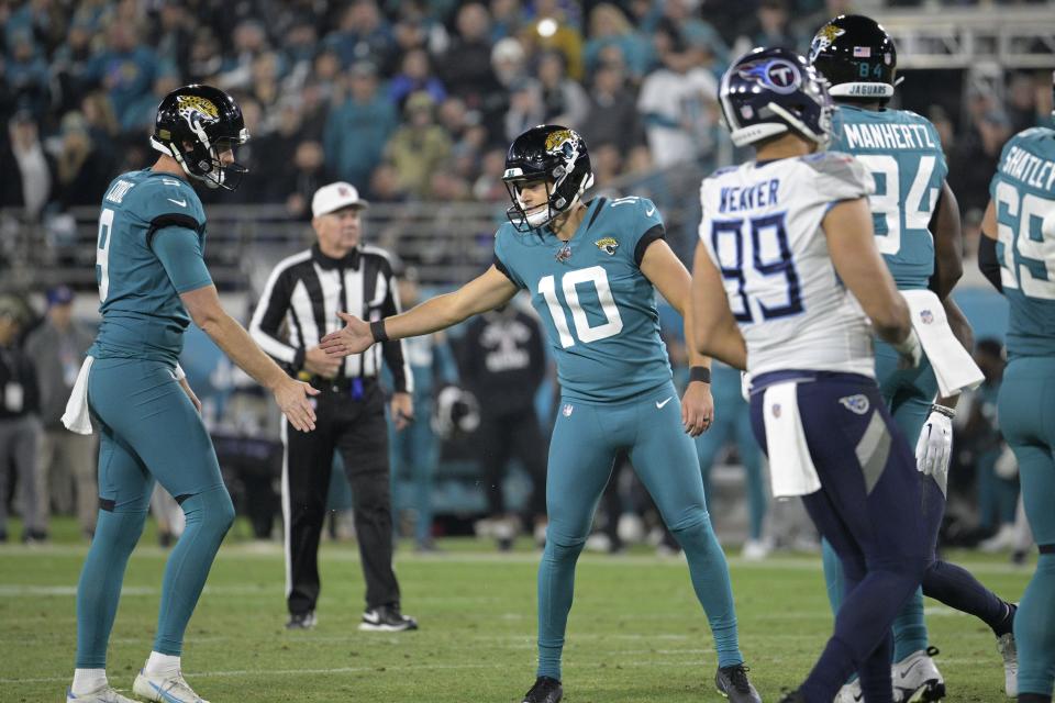 Riley Patterson of the Jaguars (10) is congratulated by holder Logan Cooke (9) after one of his two second-half field goals against the Titans on Saturday at TIAA Bank Field.
