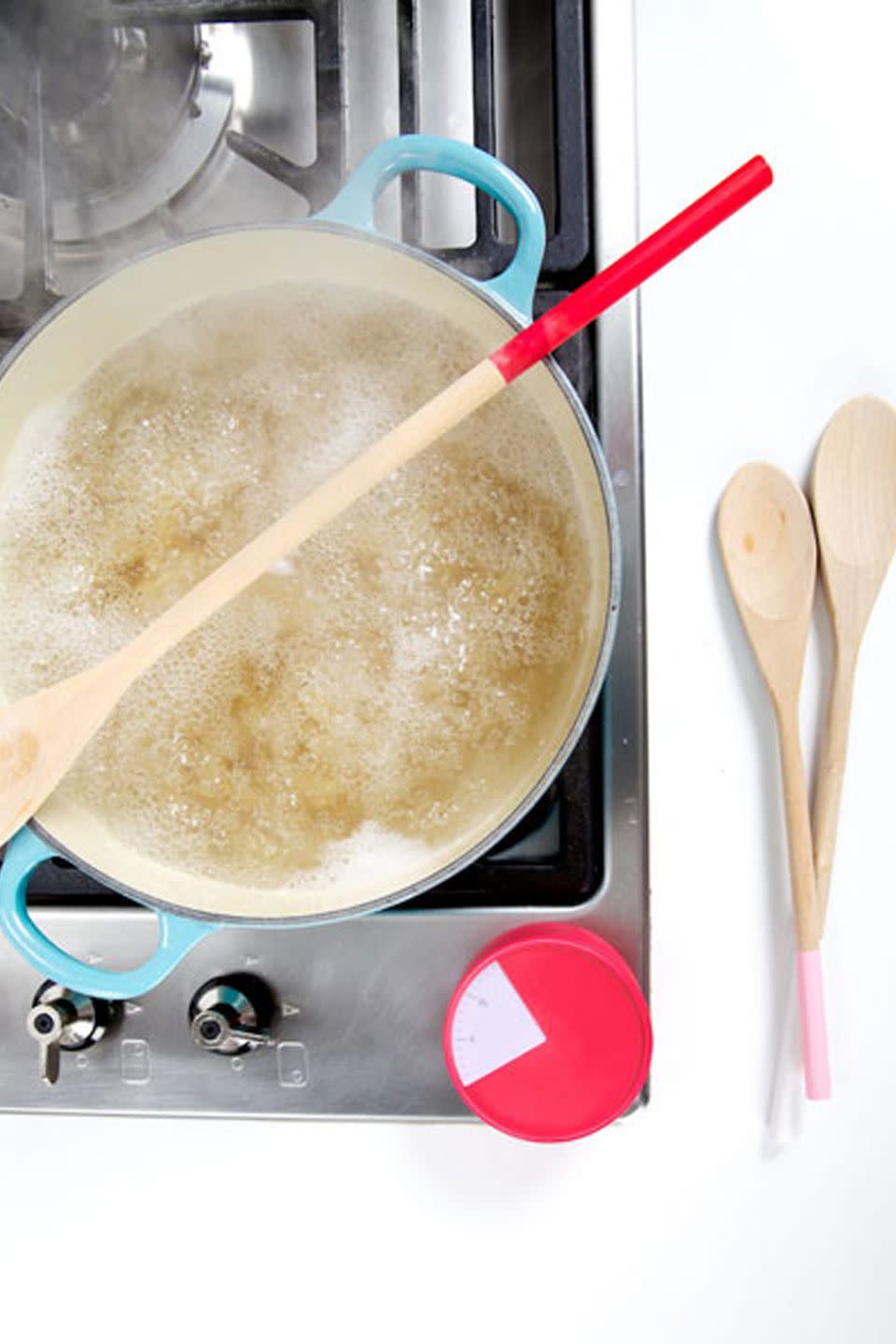 Use a wooden spoon to prevent overflow.