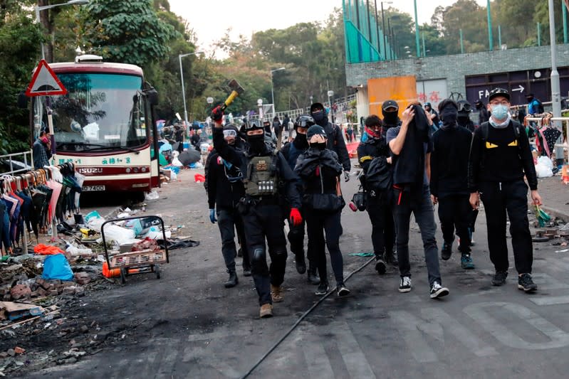 Anti-government protesters scout at a makeshift gate during a standoff with riot police at the Chinese University of Hong Kong, Hong Kong