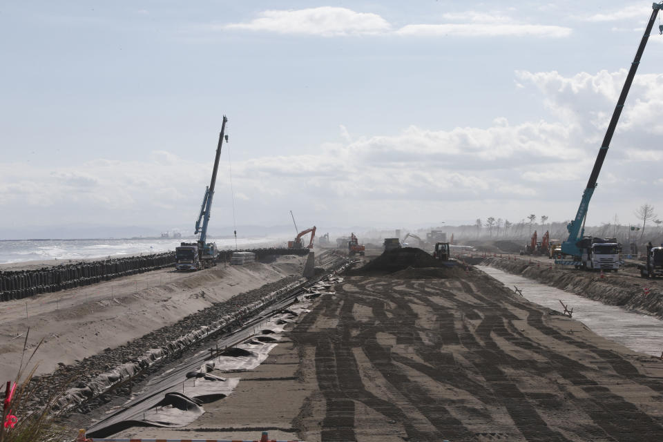 In this Oct. 9, 2012 photo, construction works go on along the Arahama beach, severely damaged by the March 11, 2011 earthquake and tsunami, in Sendai, northeastern Japan. Japan's accounting of its budget for reconstruction from the disasters is crammed with spending on unrelated projects, while all along Japan's northeastern coast, dozens of communities remain uncertain of whether, when and how they will rebuild. (AP Photo/Koji Sasahara)