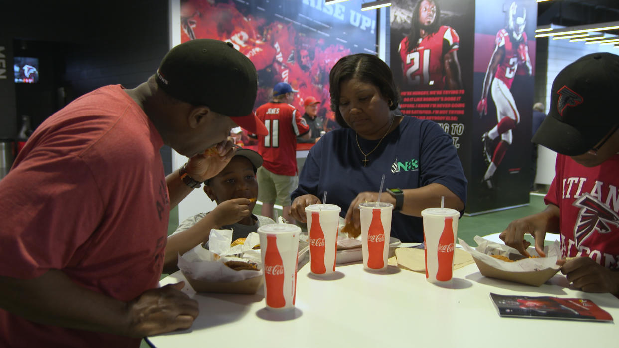 A family eats before an Atlanta Falcons preseason game on Aug. 31, 2017. (Catherine Newman/Oath)