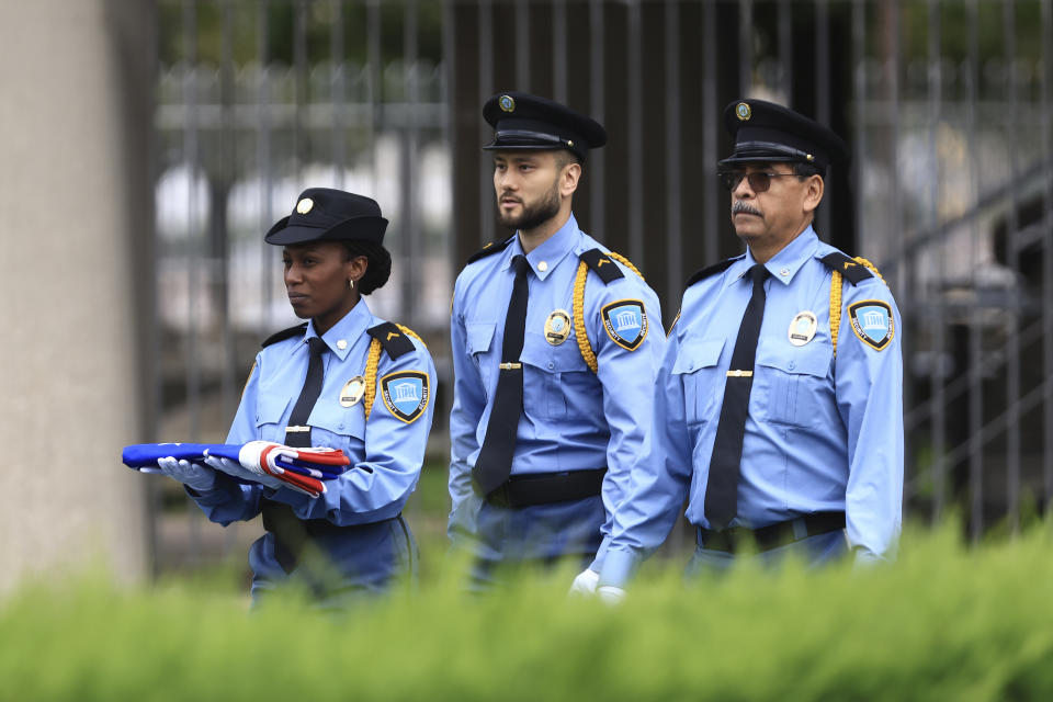 UNESCO security guards carry the American flag during a ceremony at the UNESCO headquarters Tuesday, July 25, 2023 in Paris. U.S. first lady Jill Biden is in Paris on Tuesday to attend a flag-raising ceremony at UNESCO, marking Washington's official reentry into the U.N. agency after a five-year hiatus. (AP Photo/Aurelien Morissard)