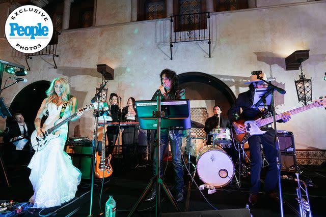<p>DeAngelo Castro for SYMBOLL</p> Nita Strauss and Alice Cooper perform at her wedding