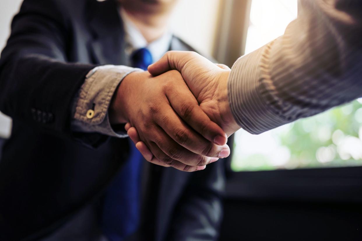 businessmen shake hands, close-up