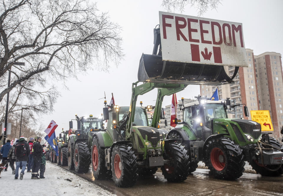 People gather in protest against COVID-19 mandates and in support of a protest against COVID-19 restrictions taking place in Ottawa, in Edmonton, Alberta, Saturday, Feb. 5, 2022. (Jason Franson/The Canadian Press via AP)