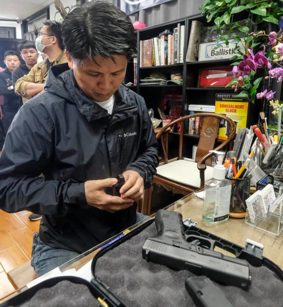 Brian Xia, 44, picks up the gun he ordered at a gun shop in Arcadia, California, on March 15. Gun sales are soaring across the country as buyers seek protection during the coronavirus pandemic.