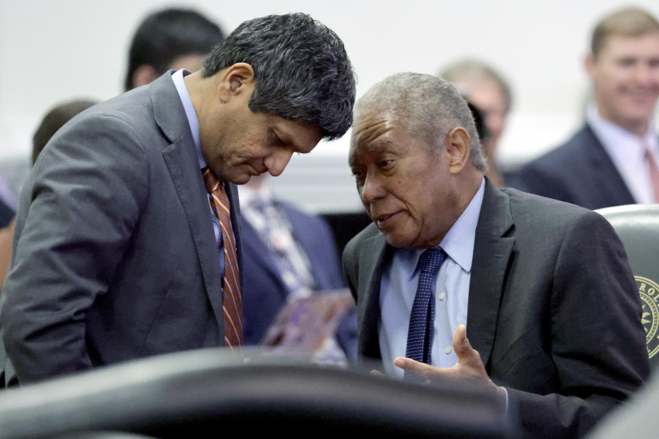 Sen. Jay Chaudhuri, D-Wake, left, and Sen. Dan Blue, D-Wake, confer after the North Carolina Senate debated and passed Republican sponsored redistricting bills at the Legislative Building, Tuesday, Oct. 24, 2023, in Raleigh, N.C. Both lawmakers spoke against the bills. (AP Photo/Chris Seward)