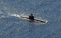 In this aerial photo taken from a maritime patrol aircraft of 800 Air Squadron of the 2nd Air Wing of Naval Aviation Center (PUSPENERBAL), the Indonesian Navy submarine KRI Alugoro sails during a search for KRI Nanggala, another submarine that went missing while participating in a training exercise on Wednesday, in the waters off Bali Island, Indonesia, Thursday, April 22, 2021. Indonesia's navy ships on Thursday were intensely searching for the submarine that likely fell too deep to retrieve, making survival chances for all the crew on board slim. Authorities said oxygen in the submarine would run out by early Saturday. (AP Photo/Eric Ireng)