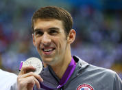 <b>Medal No. 18: </b>Silver medalist Michael Phelps poses with his medal during the medal ceremony for the Men's 200m Butterfly at the 2012 Olympics in London.