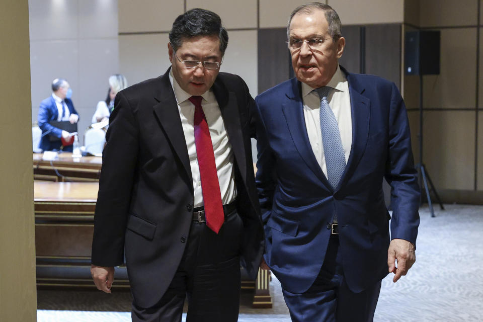 In this handout photo released by Russian Foreign Ministry Press Service, Russian Foreign Minister Sergey Lavrov, right, and Chinese Foreign Minister Qin Gang walk during their meeting in Samarkand, Uzbekistan, Thursday, April 13, 2023. (Russian Foreign Ministry Press Service via AP)