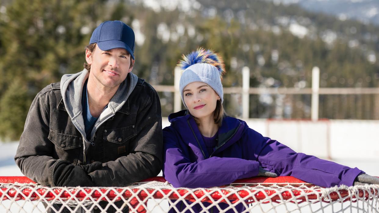  Kevin McGarry and Kim Matula next to a hockey net in Checkin' It Twice. 