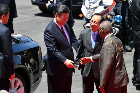 China's President Xi Jinping shakes hands with Governor General Bob Dadae after a welcoming ceremony at Parliament House in Port Moresby on November 16, 2018, ahead of the Asia-Pacific Economic Cooperation (APEC) Summit. Saeed Khan/Pool via REUTERS