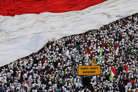 An Indonesian flag is seen during a protest by Muslim groups against Jakarta's Governor Basuki Tjahaja Purnama in Jakarta, Indonesia, November 4, 2016. Picture taken November 4, 2016. REUTERS/Beawiharta