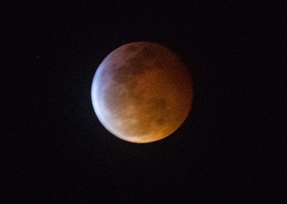 A lunar eclipse appears over Mesa, Ariz. January 20, 2019. The phenomena is otherwise known as a super blood wolf moon for its larger than normal size, the reddish color from the earth's shadow and the name given to the full moon in January.