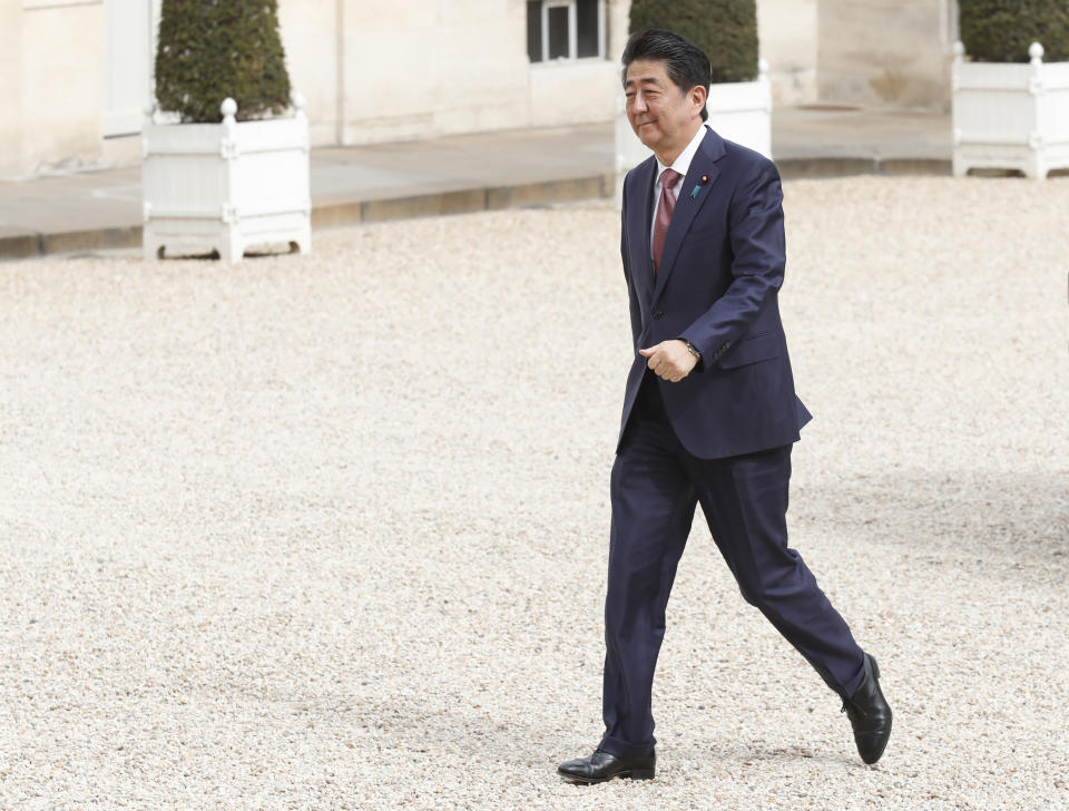 Japan's Prime Minister Shinzo Abe walks in the courtyard of the Elysee Palace before his meeting with French President Emmanuel Macron, Tuesday, April 23, 2019 in Paris. (AP Photo/Thibault Camus)