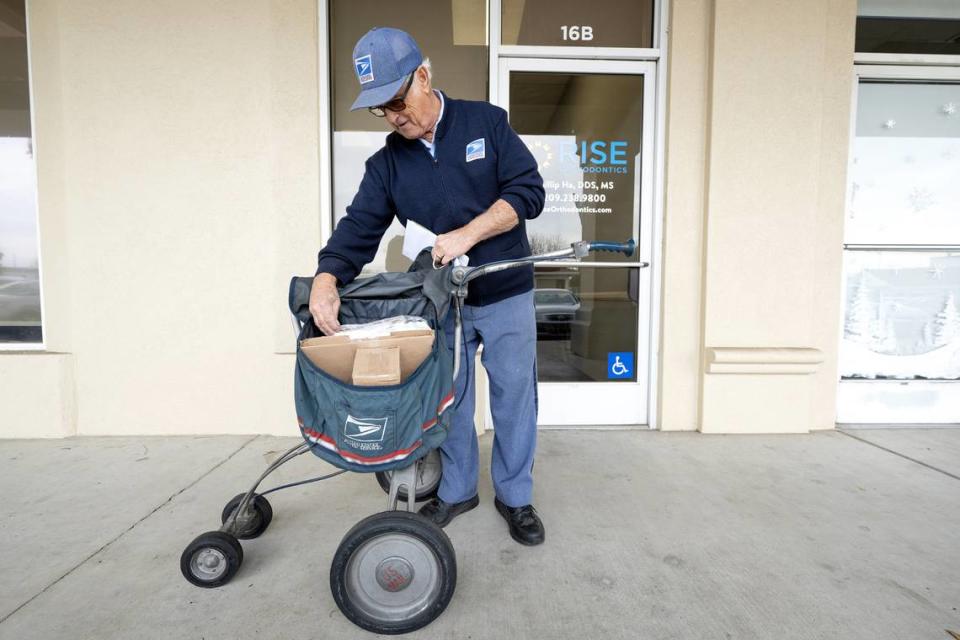 El cartero Dave Costa clasifica el correo en su ruta en McHenry Village en Modesto, California, el miércoles 27 de diciembre de 2023. Costa, quien empezó a repartir el correo en bicicleta en 1967, se jubila el miércoles tras más de 56 años en el Servicio Postal.