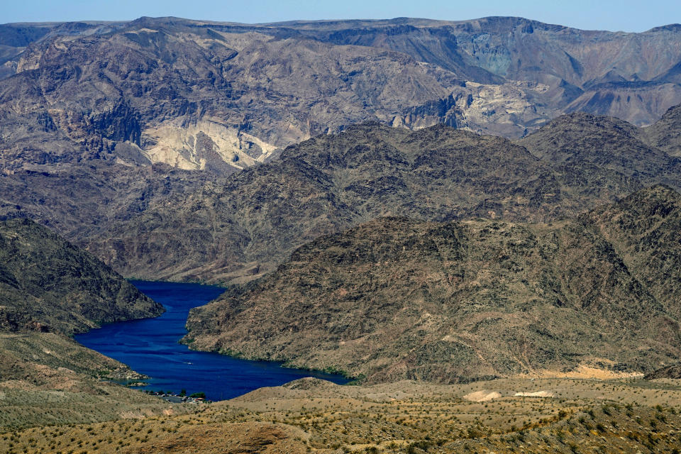 FILE - The Colorado River cuts through Black Canyon, Tuesday, June 6, 2023, near White Hills, Ariz. Federal officials said Wednesday, Oct. 25, that a voluntary plan for Colorado River water conservation by California, Arizona and Nevada should be enough to stabilize the basin for the next few years. (AP Photo/Matt York,File)