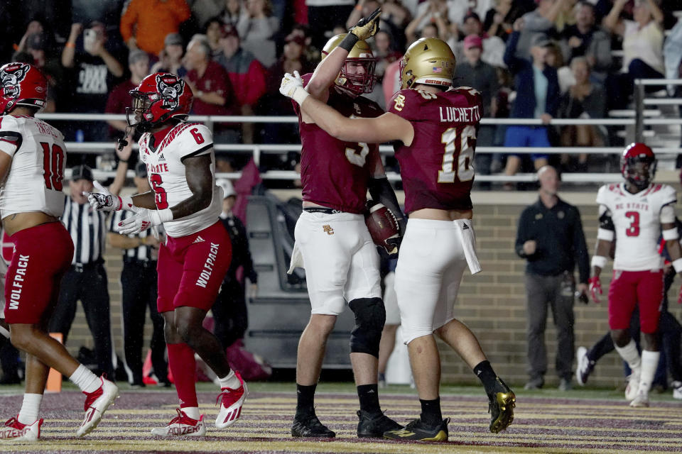 Boston College tight end Trae Barry (3) is congratulated by teammate Joey Luchetti (16) after scoring a touchdown against North Carolina State during the first half of an NCAA college football game, Saturday, Oct. 16, 2021, in Boston. (AP Photo/Mary Schwalm)