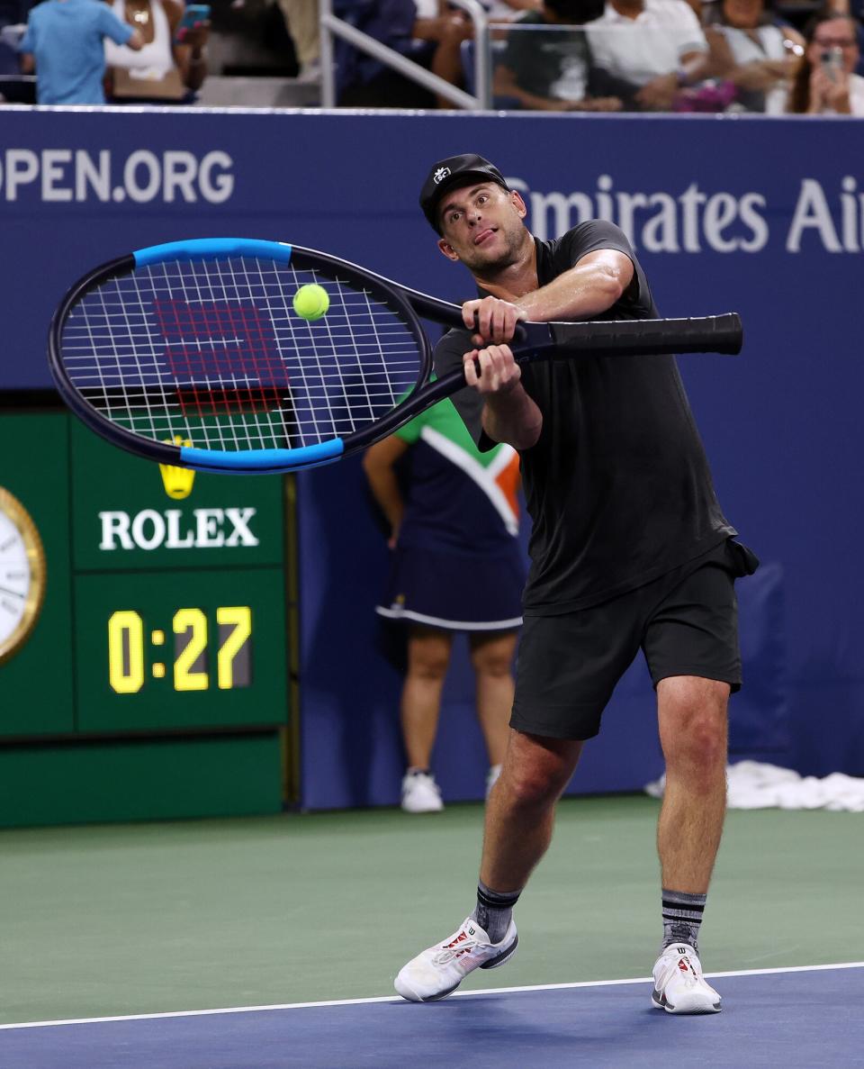 Andy Roddick uses an oversize racket during the US Open Legends Match against James Blake and Bethanie Mattek-Sands at USTA Billie Jean King National Tennis Center on August 23, 2022 in New York City.