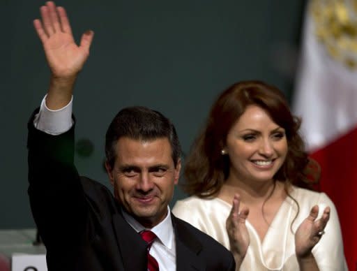 Enrique Pena Nieto with his wife Angelica Rivera waves to supporters on July 1 after learning the first official results of the presidential election. He may have won Mexico's presidential election, but charges filed by his main opponent in an electoral court threaten to undermine his legitimacy even before taking office