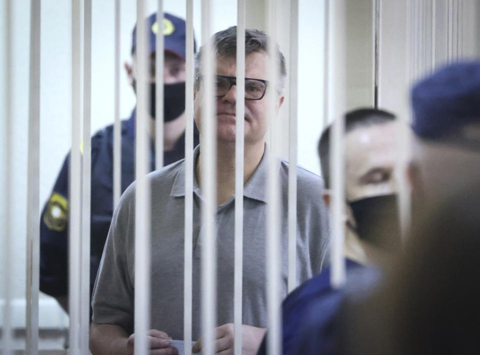 Viktor Babariko, the former head of Russia-owned Belgazprombank, stands inside a cage in a court room in Minsk, Belarus, Tuesday, July 6, 2021. The Supreme Court in Belarus has sentenced a former contender in the 2020 presidential race to 14 years in prison on corruption charges in a case that has been widely seen as politically motivated. Viktor Babariko, the former chief executive of a Russia-owned bank, aspired to challenge Belarus' authoritarian president Alexander Lukashenko in last year's election. (Ramil Nasibulin/BelTA Pool Photo via AP)