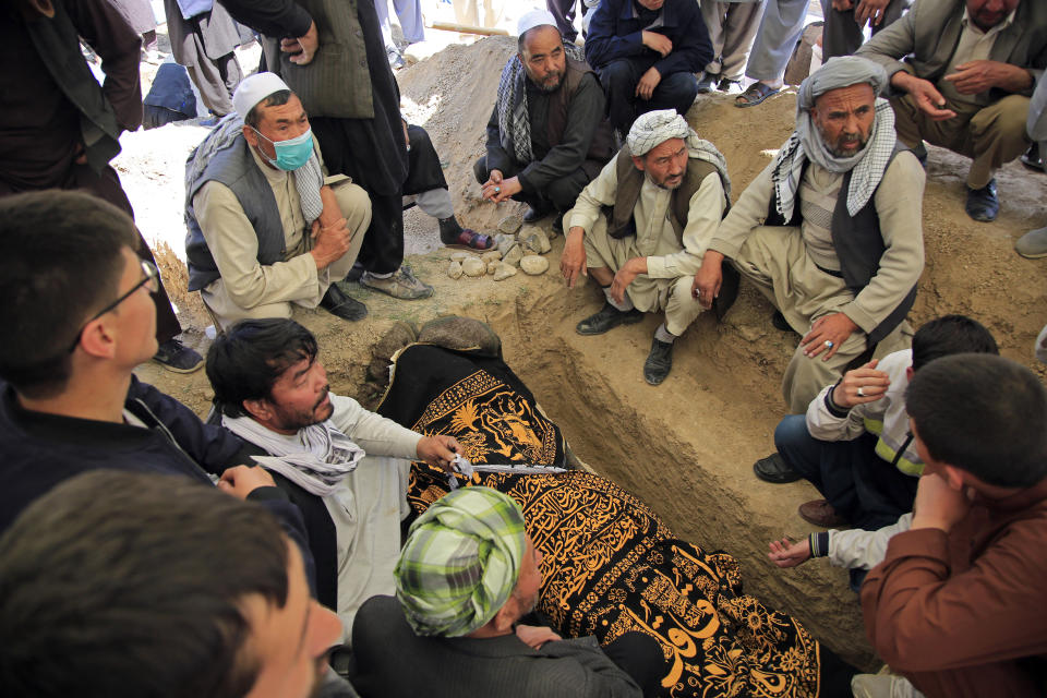 Afghan men bury a victim of deadly bombings on Saturday near a school, at a cemetary west of Kabul, Afghanistan, Sunday, May 9, 2021. The Interior Ministry said Sunday the death toll in the horrific bombing at the entrance to a girls' school in the Afghan capital has soared to some 50 people, many of them pupils between 11 and 15 years old, and the number of wounded in Saturday's attack has also climbed to more than 100. (AP Photo/Mariam Zuhaib)