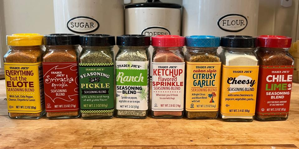 Eight Trader Joe's seasoning blends lined up on a table.