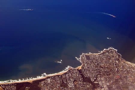 Sediment can be seen in the water as ships and boats sail past the coastal town of Hervey Bay, north of Brisbane in Queensland, Australia, June 9, 2015. REUTERS/David Gray