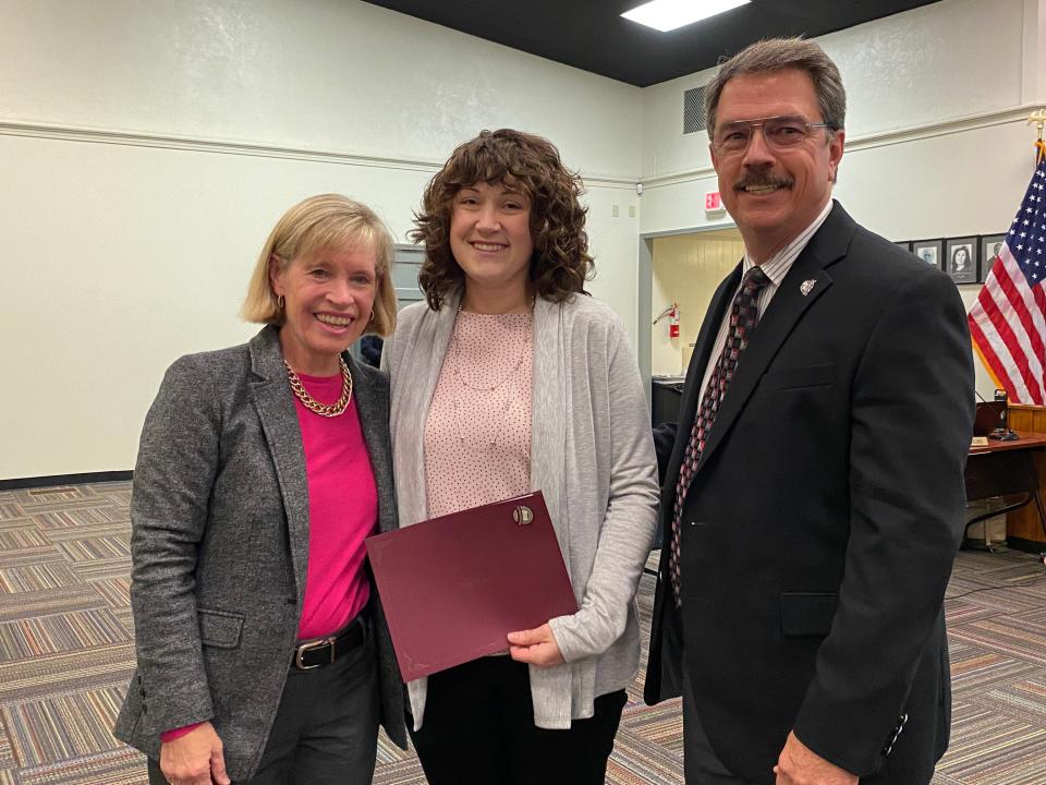 Oak Ridge Board of Education member Laura McLean, left, and administrator Bruce Lay, right, join with Leah Hunter, who was recognized at the Nov. 22 Board meeting for helping a 6-year-old who was reportedly let off one-half mile from her house by a bus driver get to her home.