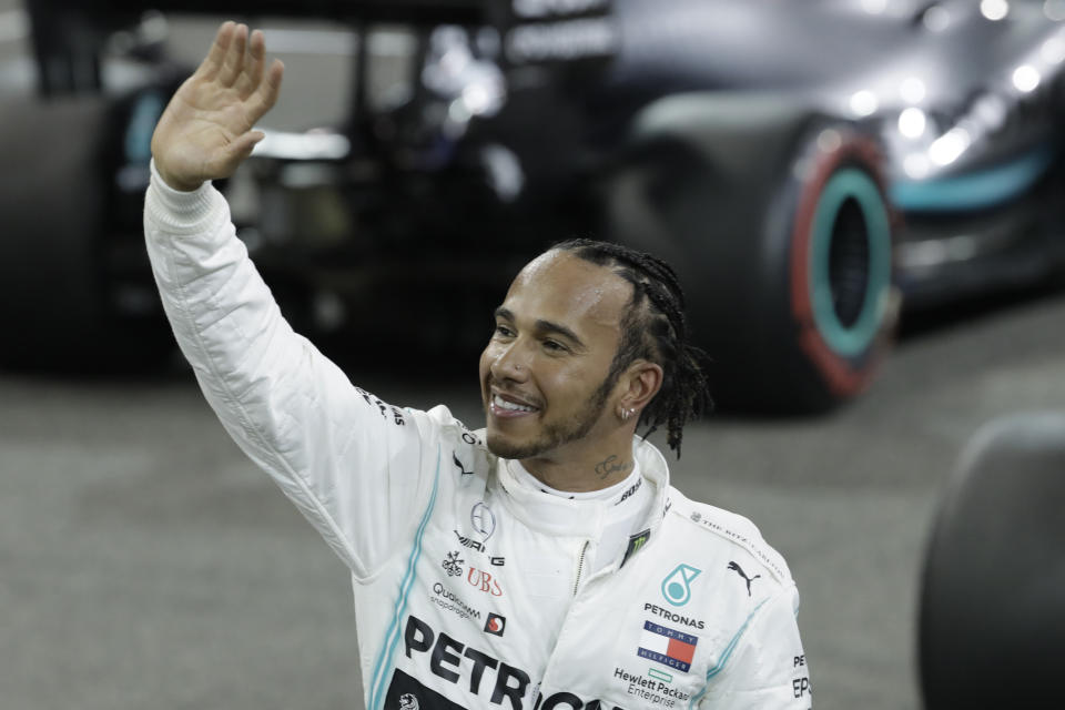 Mercedes driver Lewis Hamilton of Britain celebrates pole position during the qualifying session at the Yas Marina racetrack in Abu Dhabi, United Arab Emirates, Saturday, Nov. 30, 2019. The Emirates Formula One Grand Prix will take place on Sunday. (AP Photo/Luca Bruno)