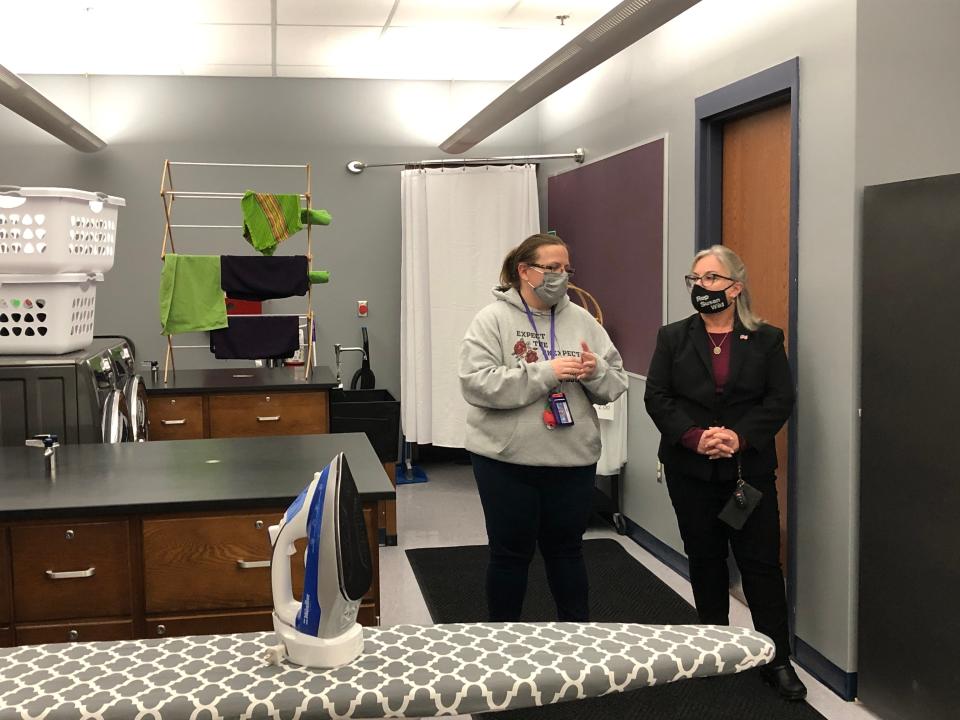 Laundry hangs in the background as Amanda Kerdzaliev, life skills teacher at East Stroudsburg High School South, left, discusses the school's new apartment-style classroom with U.S. Rep. Susan Wild on Monday, Nov. 22, 2021.