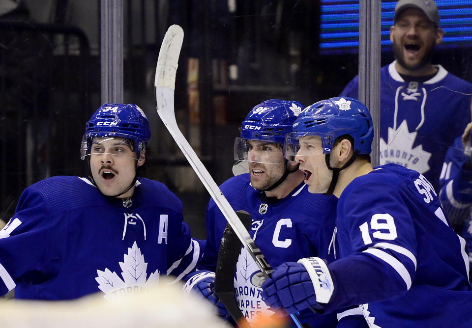 Toronto Maple Leafs center John Tavares, center, celebrates his overtime goal against the Anaheim Ducks with Auston Matthews (34) and Jason Spezza (19) in an NHL hockey game Friday, Feb. 7, 2020, in Toronto. (Frank Gunn/The Canadian Press via AP)