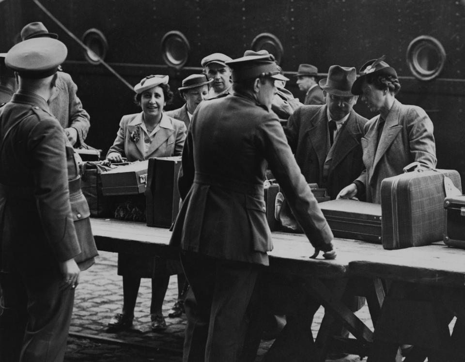 Refugees go through customs on arrival in Antwerp onboard the MS St. Louis, after over a month at sea, during which they were denied entry to Cuba, the United States and Canada. (Photo: Gerry Cranham via Getty Images)