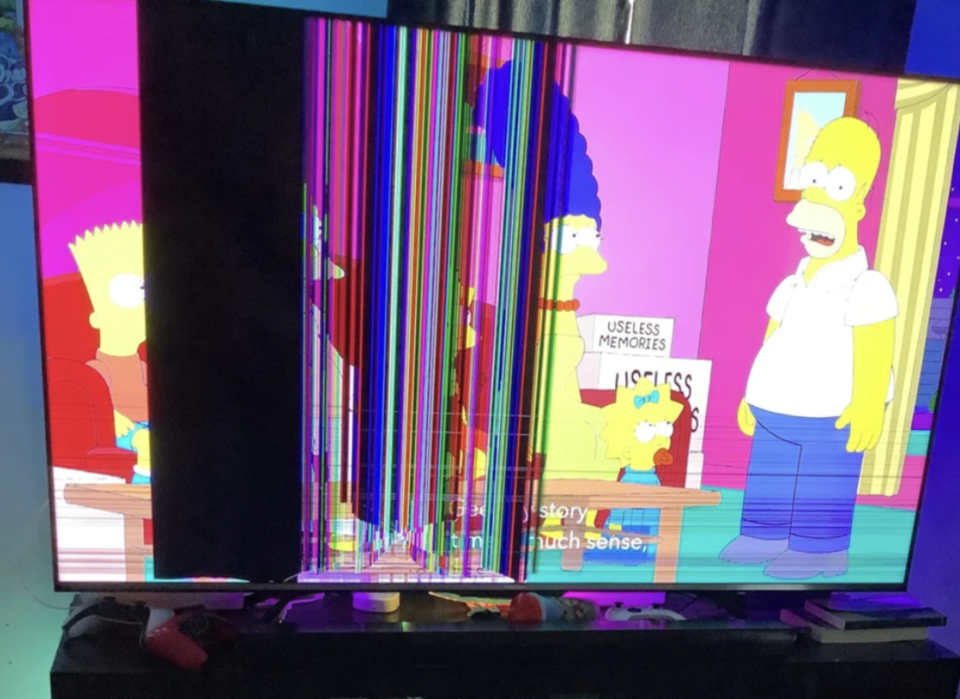 TV showing a scene from the simpsons with a bunch of random lines and blurs added because it's broken