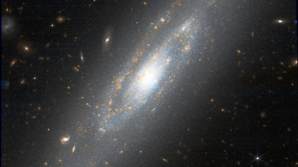     A wondrous spiral galaxy full of bright white and warm gold dots in the starry blackness of space. 