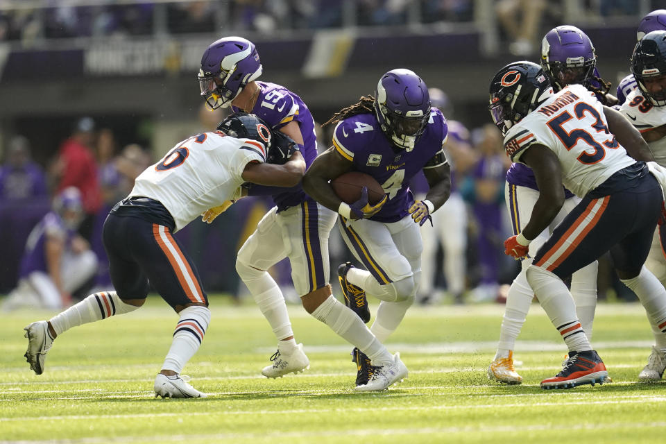 Minnesota Vikings running back Dalvin Cook (4) runs from Chicago Bears linebacker Nicholas Morrow (53) during the first half of an NFL football game, Sunday, Oct. 9, 2022, in Minneapolis. (AP Photo/Abbie Parr)