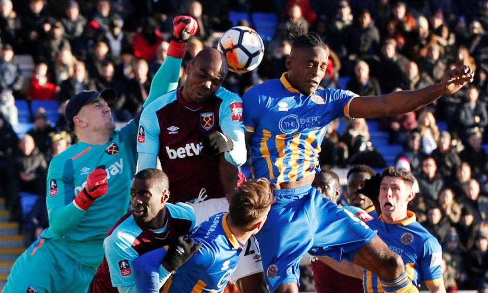 Joe Hart, wearing a cap thrown to him by a supporter, comes under pressure against Shrewsbury