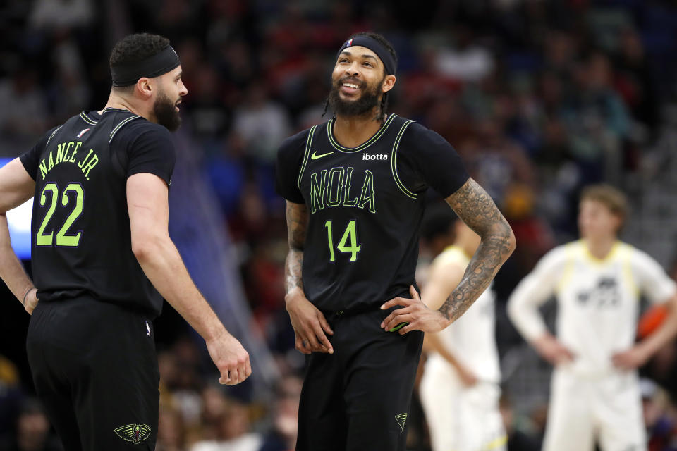 New Orleans Pelicans forward Brandon Ingram (14) and forward Larry Nance Jr. (22) react to play during the first half of the team's NBA basketball game against the Utah Jazz in New Orleans, Tuesday, Jan. 23, 2024. (AP Photo/Tyler Kaufman)