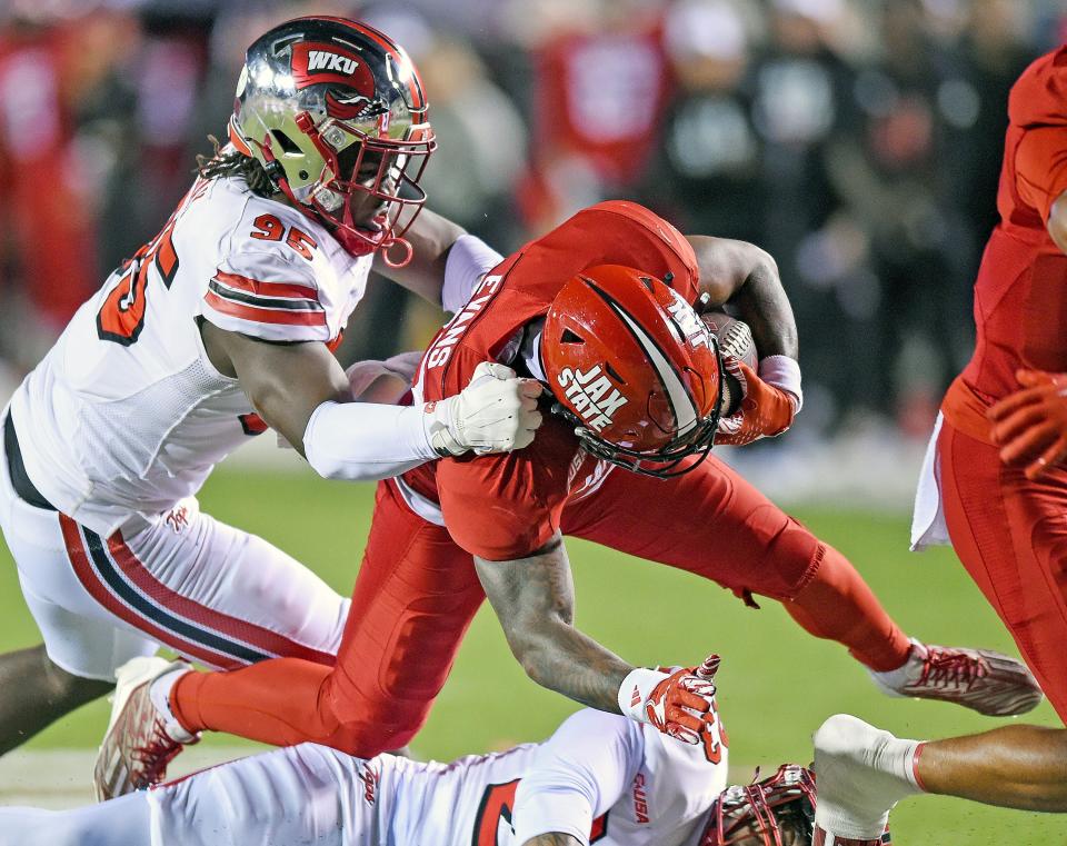 Jacksonville State's J'Wan Evans tries to evade the tackle of Western Kentucky's Deante McCray.