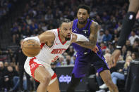 Houston Rockets forward Dillon Brooks (9) is guarded by Sacramento Kings guard Malik Monk during the first half of an NBA basketball game in Sacramento, Calif., Sunday, March 10, 2024. (AP Photo/Randall Benton)