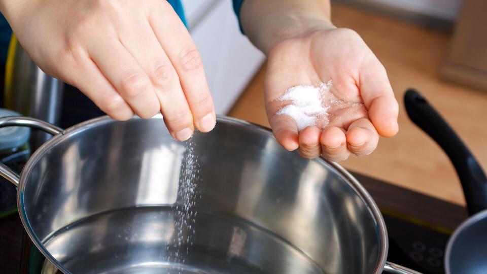 person salting water