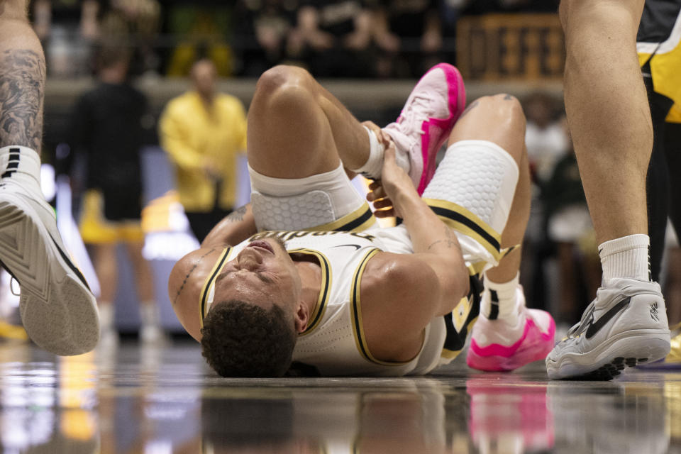 Purdue forward Mason Gillis reacts after colliding with teammate Zach Edey during the first half of an NCAA college basketball game against Iowa, Monday, Dec. 4, 2023, in West Lafayette, Ind. (AP Photo/Doug McSchooler)