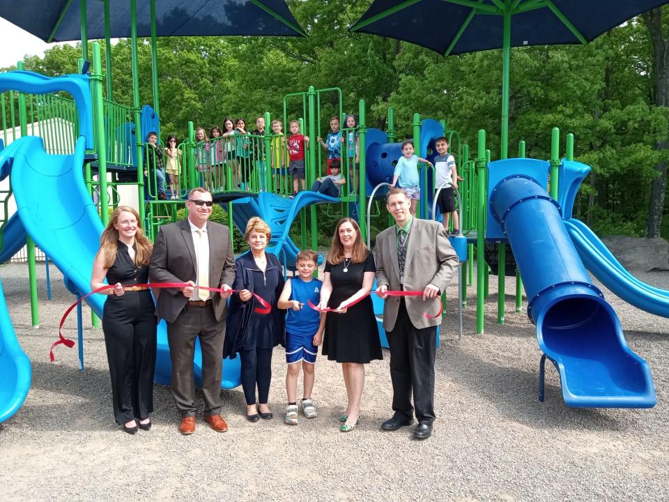 Welcoming the new playground at Wallenpaupack North Primary School on May 21, 2024, was a group of children at recess, and these adults. Second grader Lucas Eckert, center, cut the ribbon. In front, from left are Kristine Bush, representing state Sen. Rosemary Brown; North Primary Principal Kevin Kromko; Head Teacher Denise Genello; Lucas; state Sen. Lisa Baker and Wallenpaupack Superintendent Keith Gunuskey.