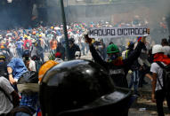 <p>A demonstrator holds a sign that reads ‘Maduro dictator’ at a rally against Venezuela’s President Nicolas Maduro in Caracas, Venezuela May 1, 2017. (Photo: Carlos Garcia Rawlins/Reuters) </p>