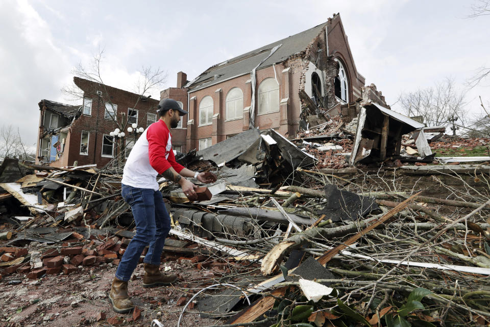 Sumant Joshi helps to clean up rubble at the East End United Methodist Church after it was heavily damaged by storms Tuesday, March 3, 2020, in Nashville, Tenn. Joshi is a resident in the area and volunteered to help clean up. Tornadoes ripped across Tennessee early Tuesday, shredding buildings and killing multiple people. (AP Photo/Mark Humphrey)