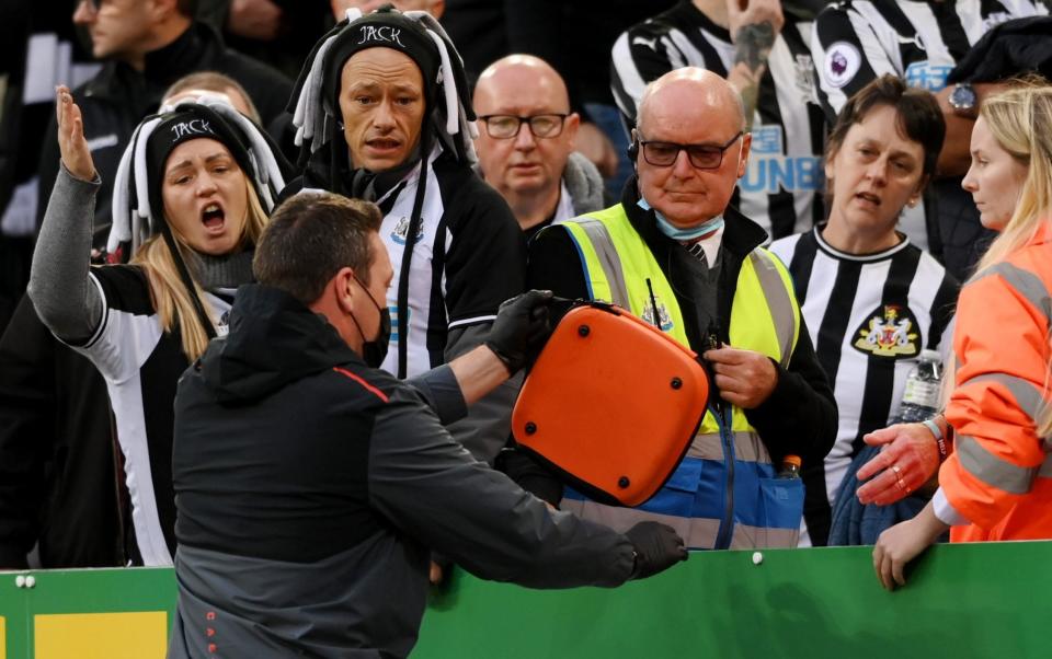 A member of medical staff from Newcastle United is seen passing a defibrillator to a steward during the Premier League match between Newcastle United and Tottenham Hotspur - Stu Forster/Getty Images