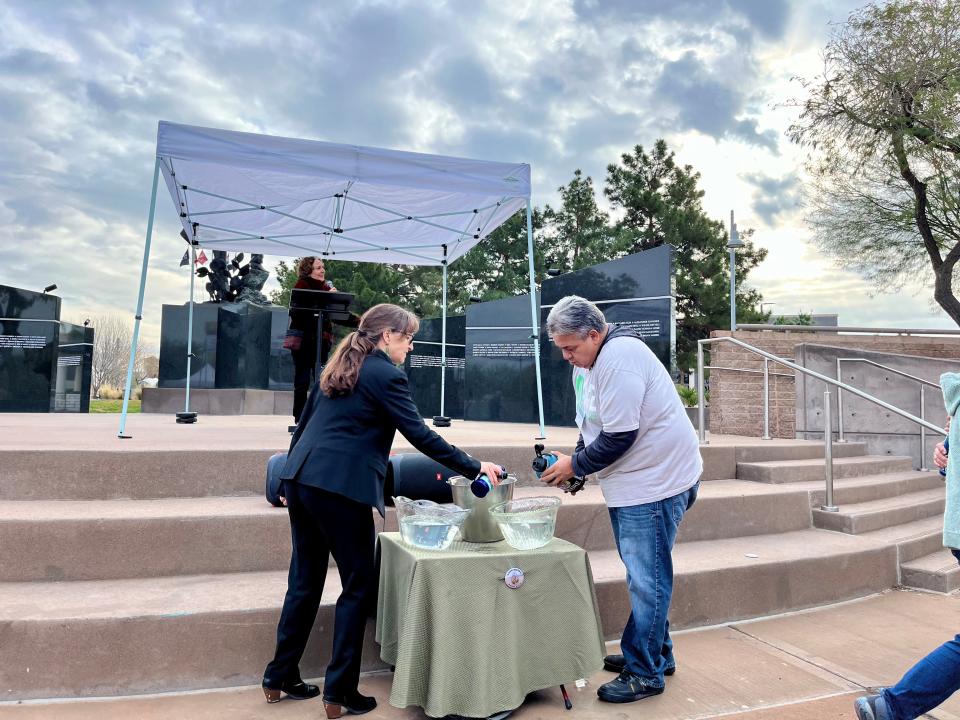 Sandy Bahr, director of the Grand Canyon Chapter of the Sierra Club, adds water to bowls set out to recognize the importance of this resource alongside another environmental activist at the Environment Day at the Arizona Capitol event on January 25, 2024.