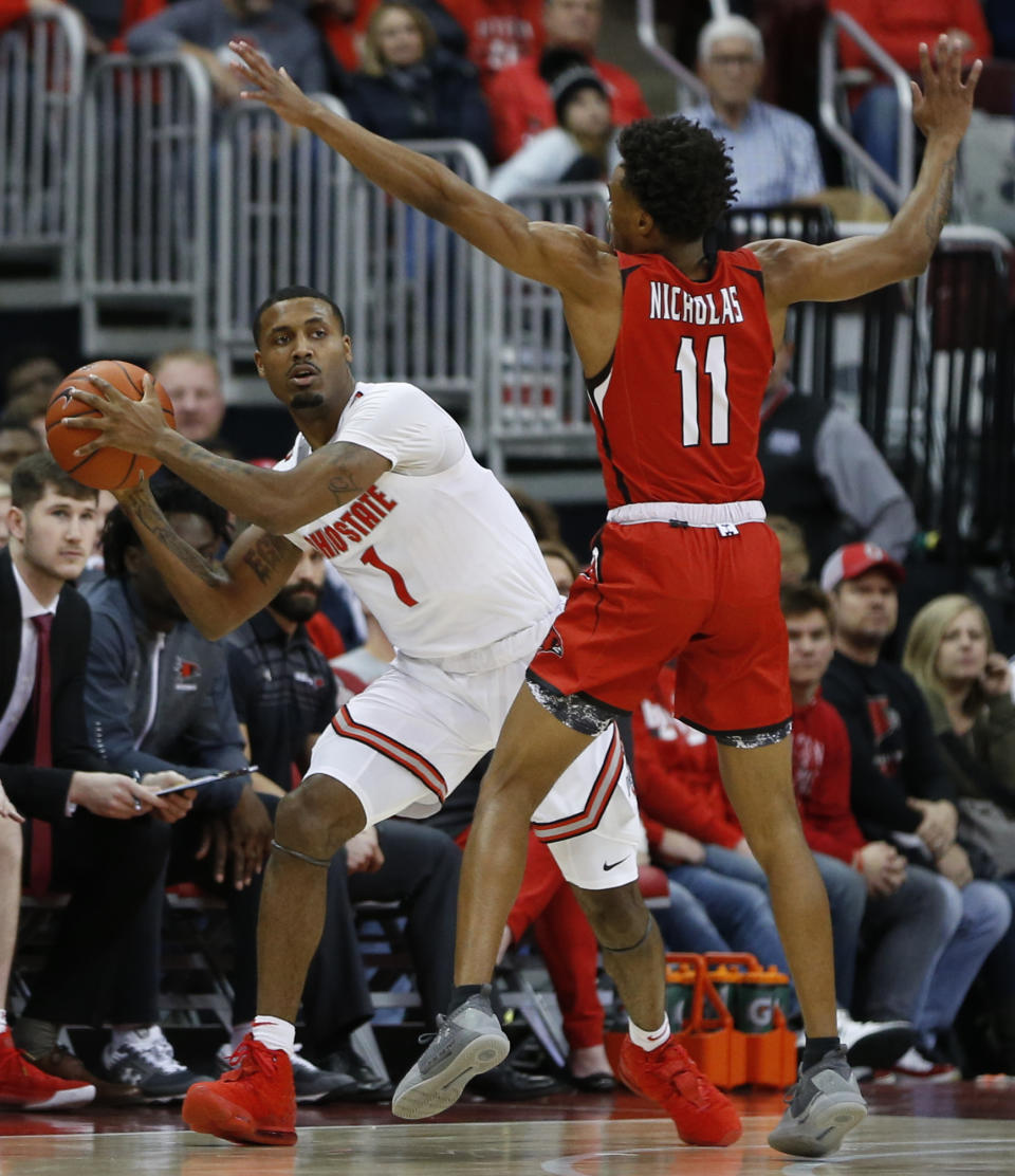 Ohio State's Luther Muhammad, left, looks for an open pass as Southeast Missouri State's DQ Nicholas defends during the first half of an NCAA college basketball game, Tuesday, Dec. 17, 2019, in Columbus, Ohio. (AP Photo/Jay LaPrete)